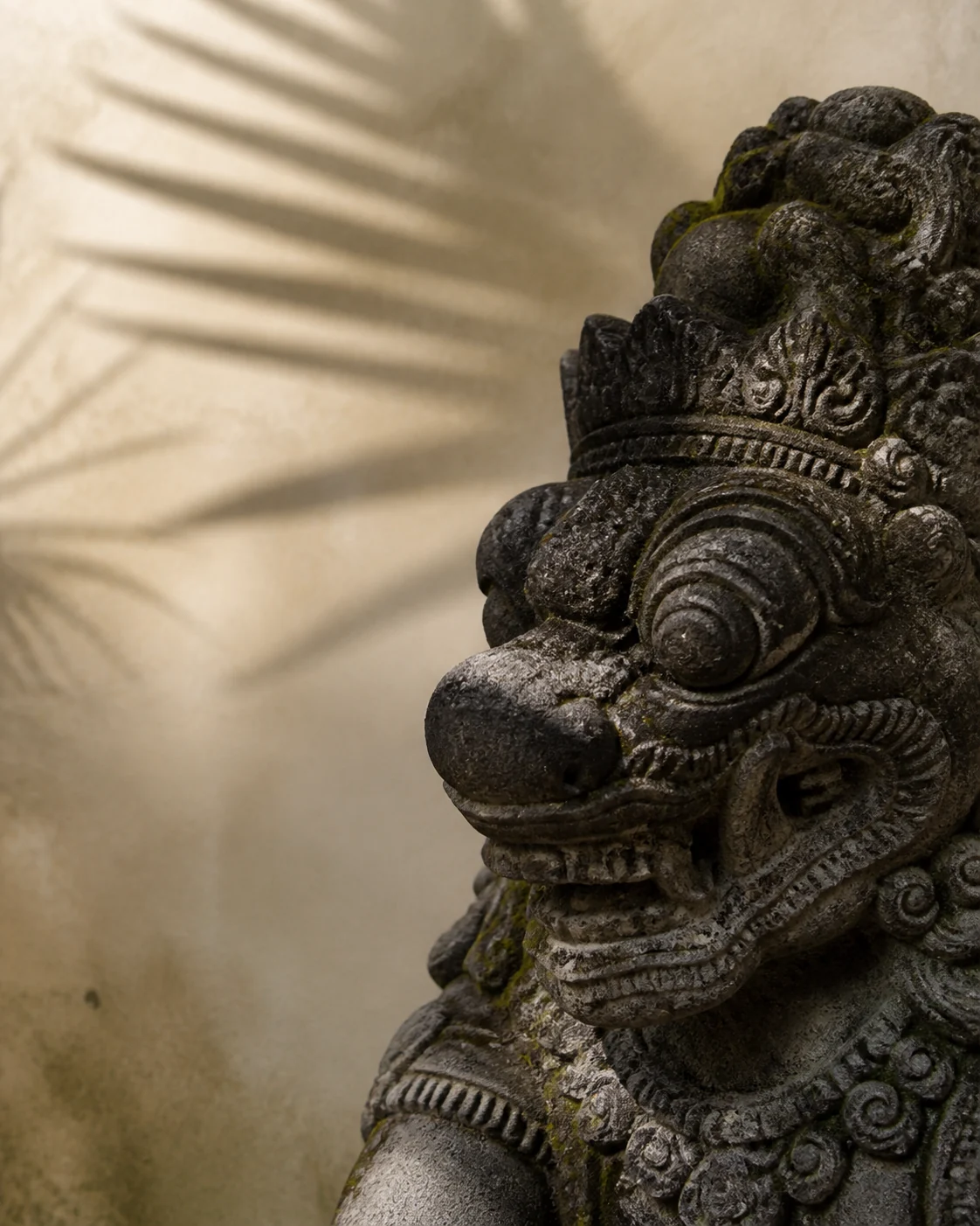 Balinese stone guardian in warm evening light